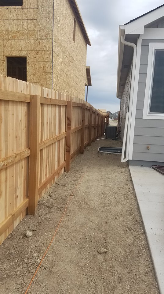 Wood privacy fence installation by Falcon Fences